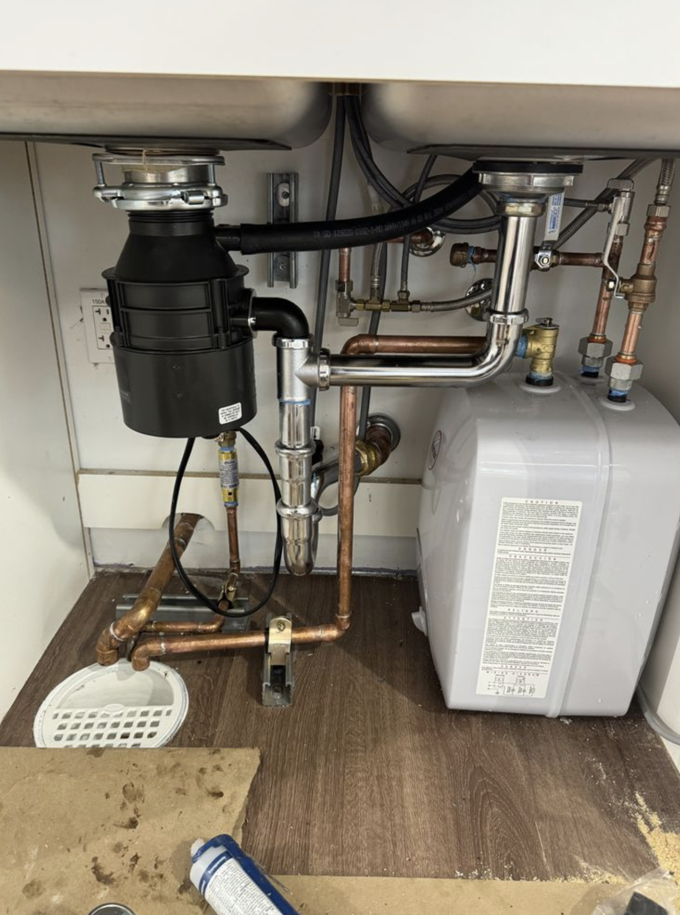 Under-sink plumbing installation with expansion tank.