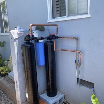 Outdoor whole-house water filtration system installation.